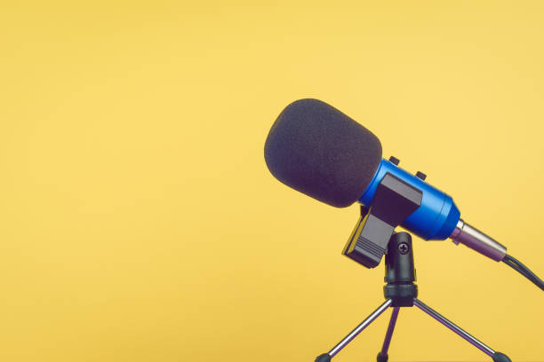 istock The blue microphone with the wire on a yellow background. 1143410908