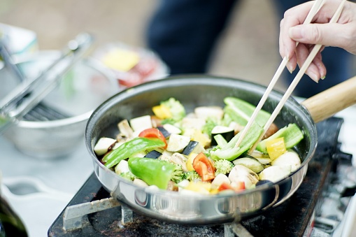 Woman is frying vegetables,Japan