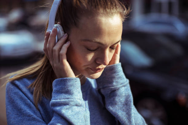Getting Ready Close up of a woman tying her hair before jogging woman tying hair in ponytail getting ready for exercising stock pictures, royalty-free photos & images