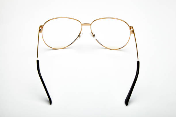 Black framed glasses that are bent on an isolated white background. Focus is on undamaged parts.