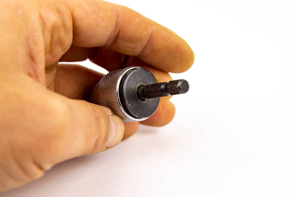 istock drill chuck in man's hand isolated on white background 1143415754