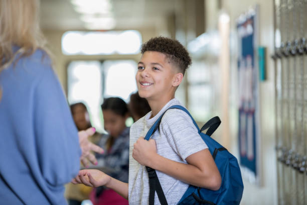 istock Male student talking to teacher in hallway 1143416851