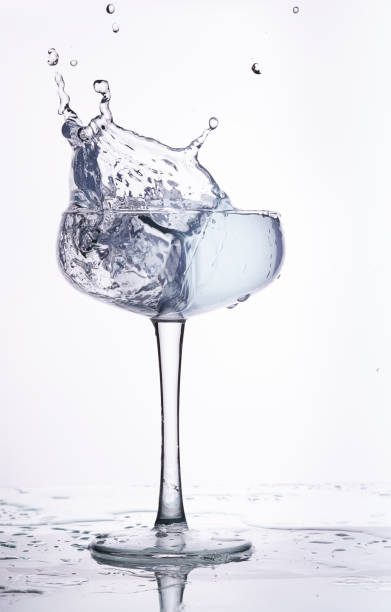 istock splash of water in a glass beaker. White background. 1143419718