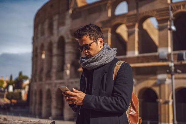 istock Man write messages from by phone in Rome, colosseum 1143420867