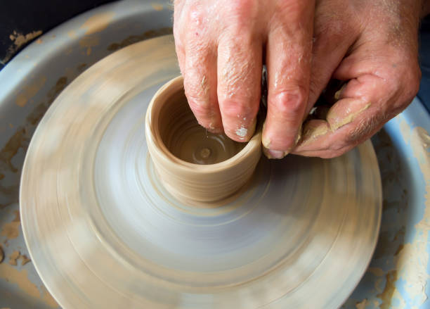 istock Potter sculpts from clay on a potter's wheel 1143422253