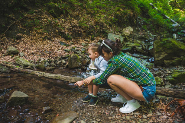 istock mother with kid near mountains river 1143424107