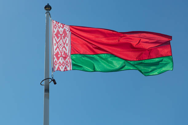 The Flag of Belarus The Flag of Belarus close up with a blue sky. belarus stock pictures, royalty-free photos & images