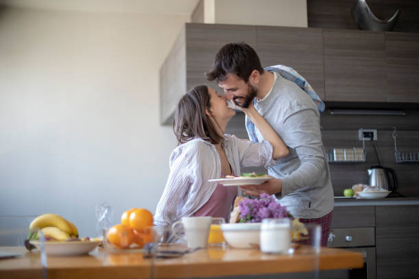 istock Young couple with vegan breakfast in dining room holds tablet 1143429139