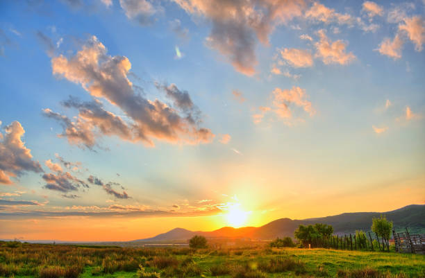 istock Colorful Summer sunset with sun rays coloring the clouds 1143431127