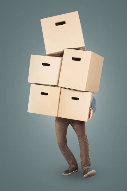 istock A man is carrying a big stack of cardboard boxes in his arms 1143433829