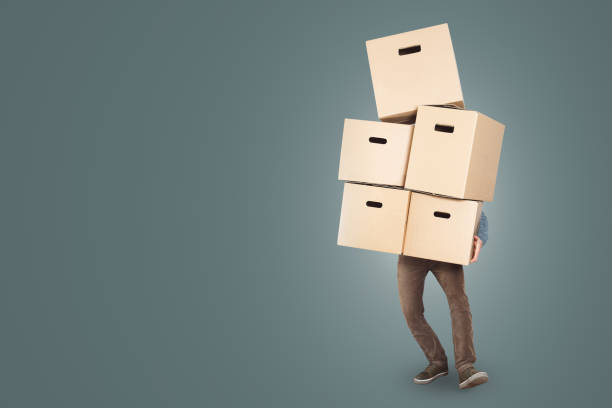 istock A man is carrying a big stack of cardboard boxes in his arms 1143433845