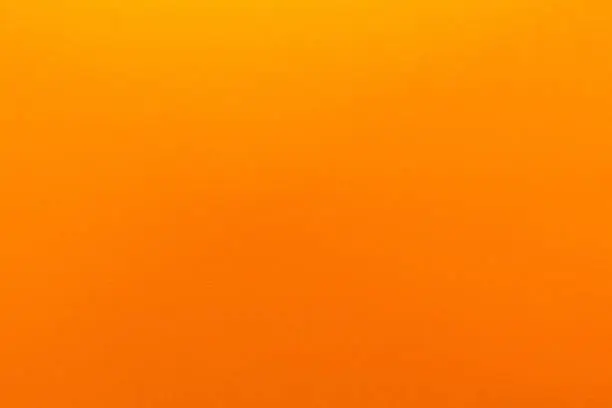 Photo of Orange gradient color with texture from real foam sponge paper for background, backdrop or design.