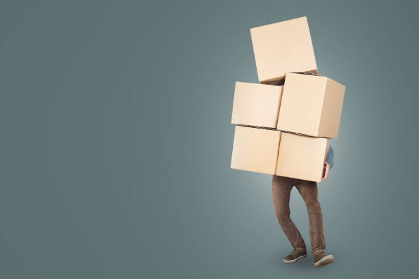 istock A man is carrying a big stack of cardboard boxes in his arms 1143434289