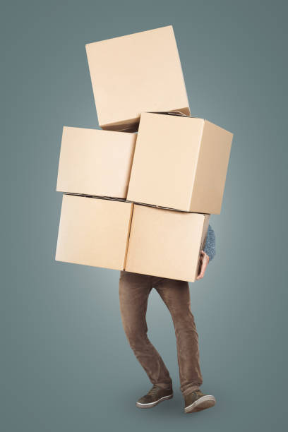 istock A man is carrying a big stack of cardboard boxes in his arms 1143434300