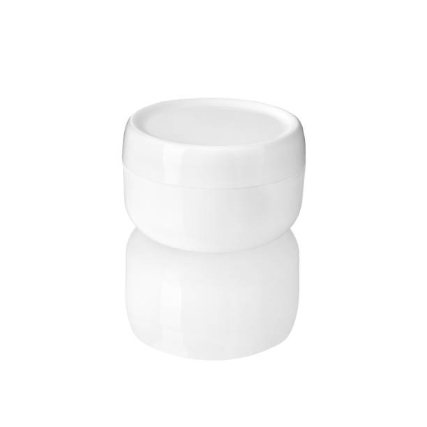 istock White round cream jar on white background isolated with reflection closeup, moisturizing hand, face or body cream circle plastic container mock up, cosmetic package product design template, copy space 1143436260
