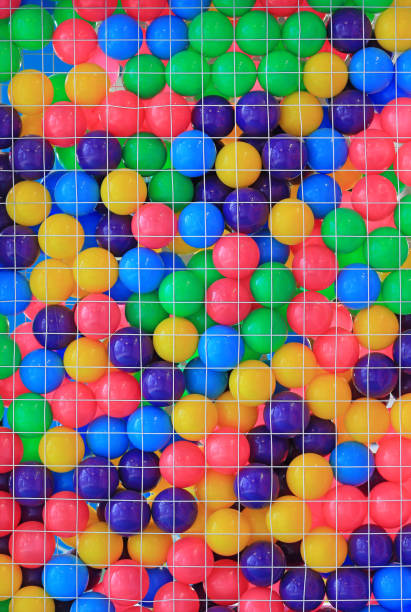 istock Colorful plastic balls in cage on children's playground. 1143436701
