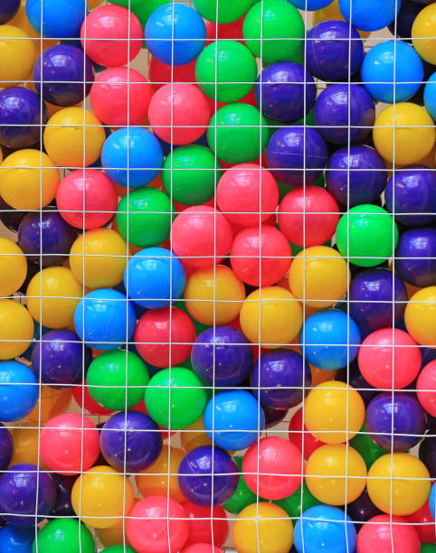 istock Colorful plastic balls in cage on children's playground. 1143436754