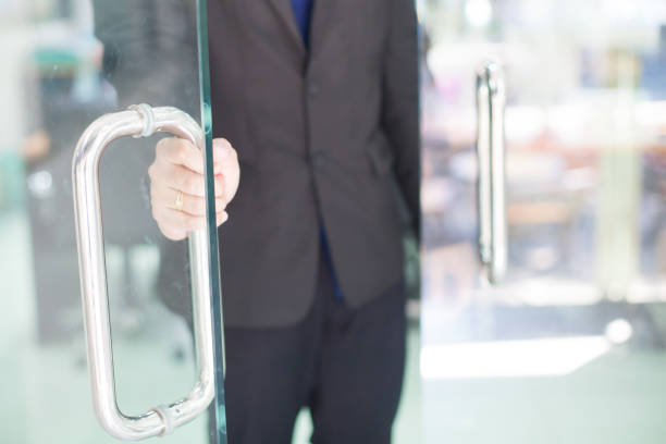 Man's hand open the door with glass reflection background