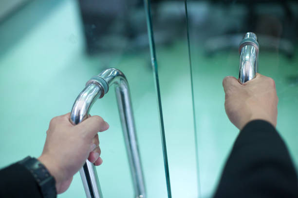 istock Man's hand open the door with glass reflection background 1143437771