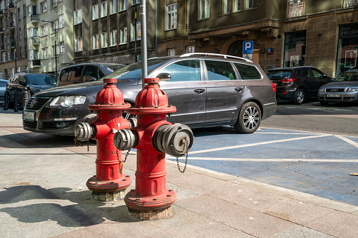 Warsaw, Poland. April 2019.   two hydrants on the sidewalk of a city center street