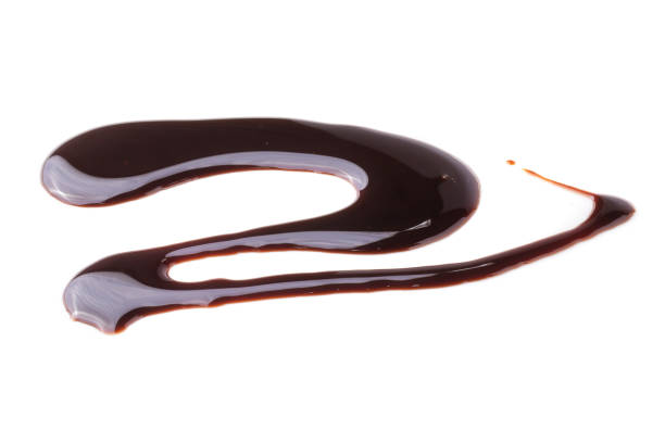 istock Abstract pattern made of chocolate Sauce isolated over white background 1143441708