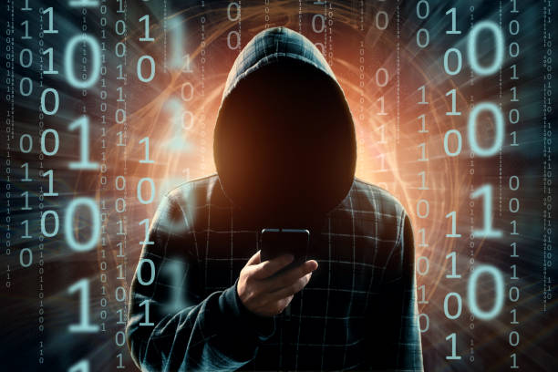 istock A young hacker in a hood hacks a smartphone, a hacker attack, a silhouette of a man, mixed media. The concept of a sudden attack, cryptography, data security, mobile Internet. 1143447332