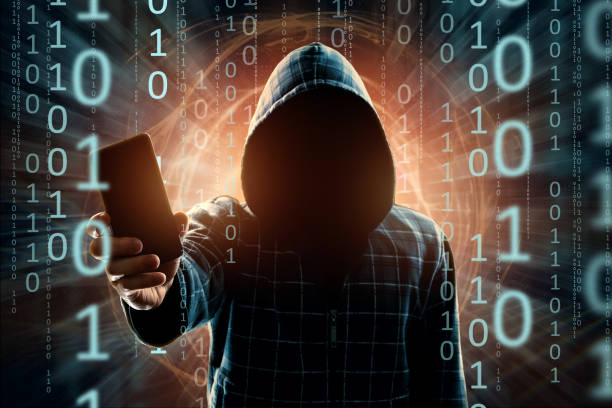 istock A young hacker in a hood hacks a smartphone, a hacker attack, a silhouette of a man, mixed media. The concept of a sudden attack, cryptography, data security, mobile Internet. 1143447344