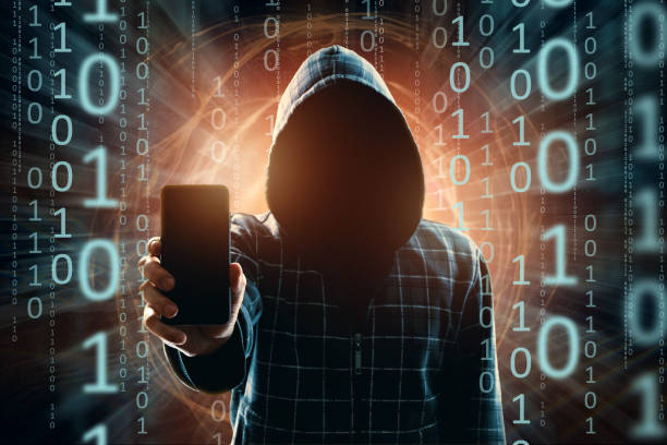 istock A young hacker in a hood hacks a smartphone, a hacker attack, a silhouette of a man, mixed media. The concept of a sudden attack, cryptography, data security, mobile Internet. 1143447359