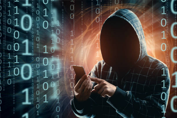 istock A young hacker in a hood hacks a smartphone, a hacker attack, a silhouette of a man, mixed media. The concept of a sudden attack, cryptography, data security, mobile Internet. 1143447407