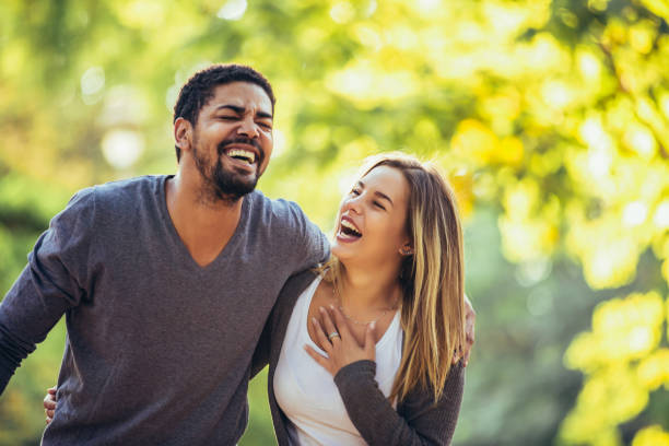 istock Young mixed couple walking in the autumn park 1143447546