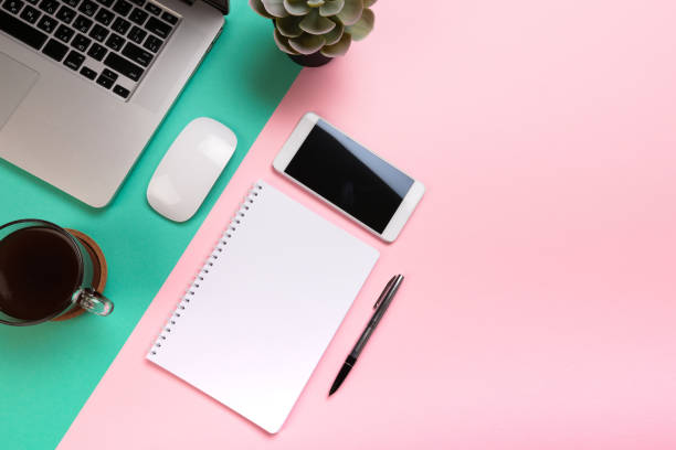 istock Pastel office desk table with laptop computer and supplies. Top view with copy space, flat lay. - Image 1143448077