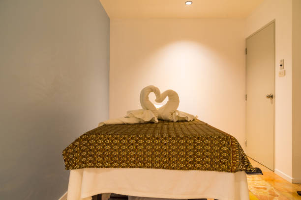 istock Interior of modern massage and spa room in warm light 1143449703