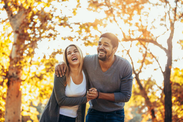 istock Young mixed couple walking in the autumn park 1143450606