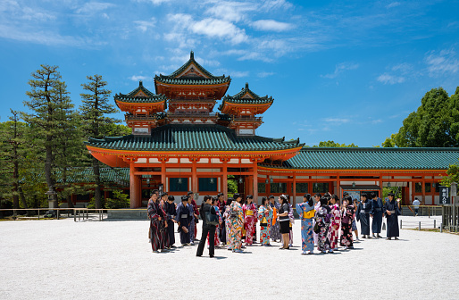 Kyoto, Japan - June 9, 2017: Local visitors in ytaditional clothing at the entrance of tthe Heian Sanctuary