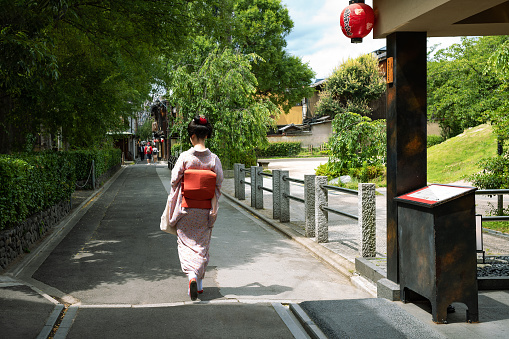 Kyoto, Japan - June 12, 2017: A lady in traditional kimono walking in a alley of the ancient Ponto-Cho district