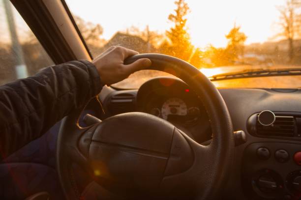 driving a car on a hot summer sunny day. hands of the driver behind the wheel. driving a car on a hot summer sunny day. hands of the driver behind the wheel. driver occupation stock pictures, royalty-free photos & images