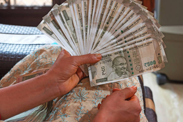 istock Woman counting Indian paper currency-image 1143461040