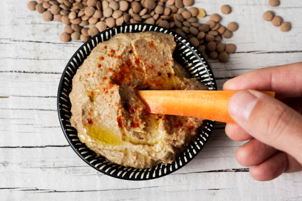 istock dipping carrot in a homemade lentil hummus 1143462021