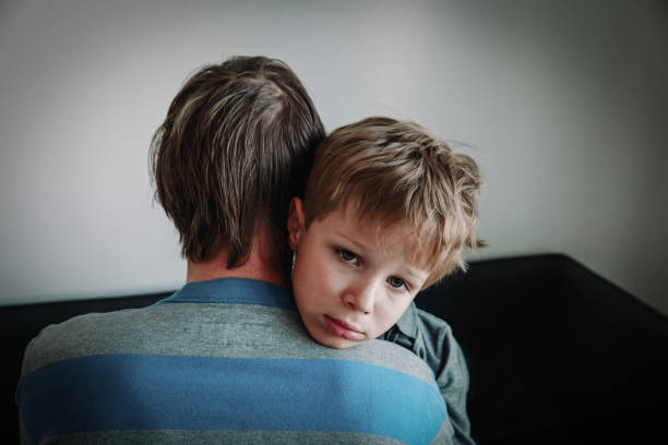 istock father comforting stressed sad son, depression and sorrow 1143462221