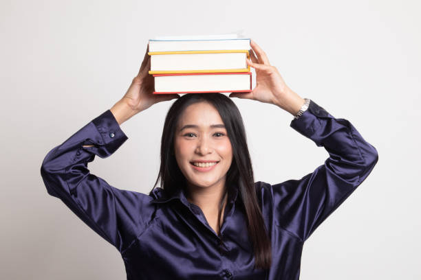 istock Young Asian woman studying  with may books. 1143462417