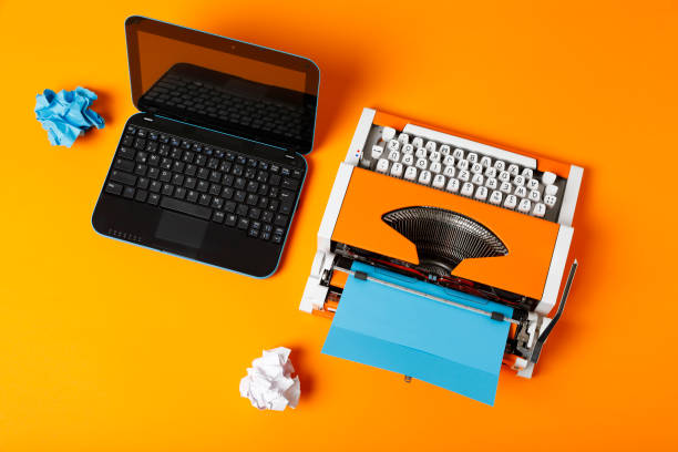 istock Digital and analog – Laptop and 70s Typewriter 1143463032