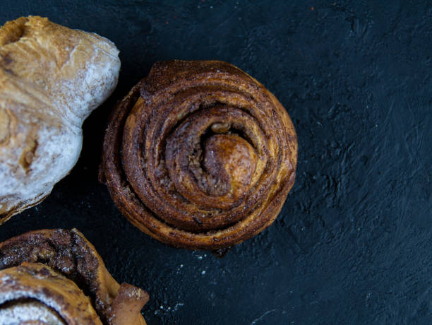 istock Sweet buns on a dark stone background 1143466493