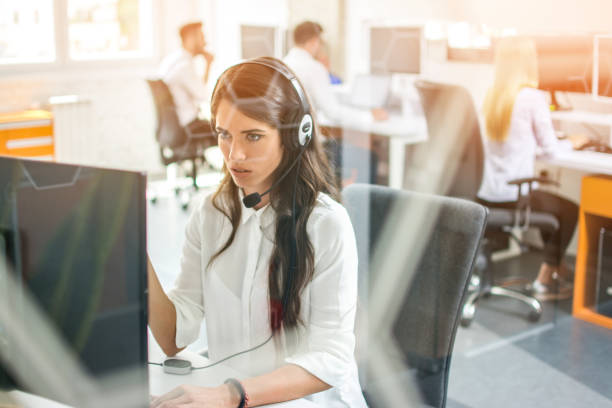 istock Confused female customer support operator working on computer at her workplace in call center 1143466997