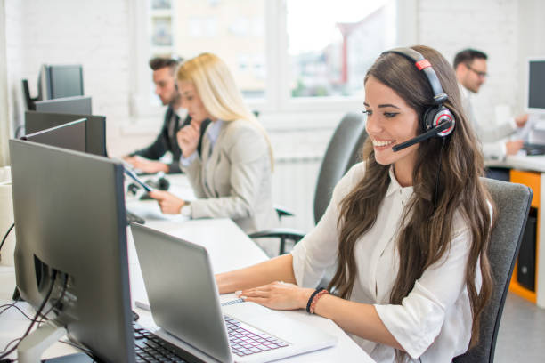 istock Beautiful young woman with headset using laptop while talking with client. Online customer support. 1143468107