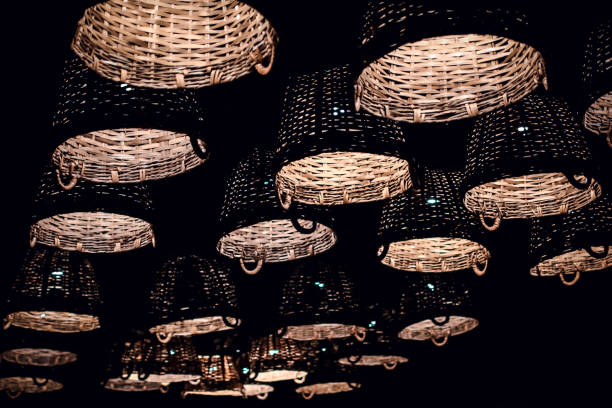 Local shaped lamps on ceiling against dark background, many local ceiling lamps with abstract ornament as chandelier