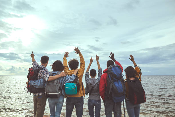 istock Group of people jumping with their hands up 1143469664