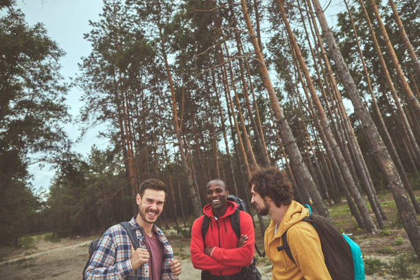 istock Happy mates making jokes during hiking through forest 1143469716