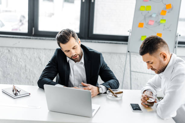 istock tired businessmen having discussion in modern office 1143470792