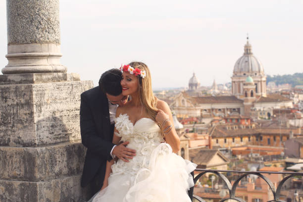 Happy beautiful wedding couple posing in city