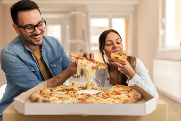Happy couple eating pizza.